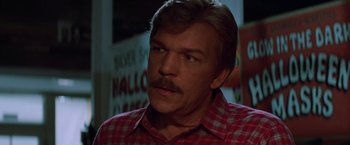 Movie still from “Halloween III: Season of the Witch” (1982), directed by Tommy Lee Wallace – A person wearing a plaid shirt; Close Up shot, Low angle