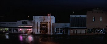 Movie still from “Halloween III: Season of the Witch” (1982), directed by Tommy Lee Wallace – A building that has a cross on top of it; Extreme Wide shot, High angle