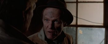 Movie still from “Halloween III: Season of the Witch” (1982), directed by Tommy Lee Wallace – A person wearing a hat; Close Up shot, Over the shoulder angle