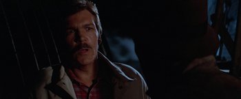 Movie still from “Halloween III: Season of the Witch” (1982), directed by Tommy Lee Wallace – A person with a mustache wearing a jacket; Close Up shot, Low angle