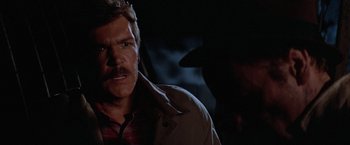 Movie still from “Halloween III: Season of the Witch” (1982), directed by Tommy Lee Wallace – A person wearing a hat and a jacket; Close Up shot, Over the shoulder angle