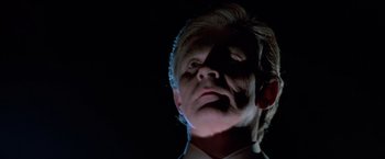 Movie still from “Halloween III: Season of the Witch” (1982), directed by Tommy Lee Wallace – A person wearing a suit and tie; Close Up shot, Low angle