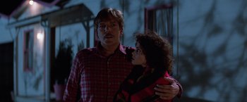 Movie still from “Halloween III: Season of the Witch” (1982), directed by Tommy Lee Wallace – A man and a woman standing next to each other; Medium shot, Low angle