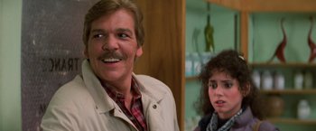 Movie still from “Halloween III: Season of the Witch” (1982), directed by Tommy Lee Wallace – A man and a woman are smiling for the camera; Close Up shot, Low angle