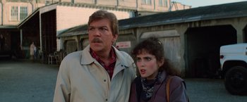 Movie still from “Halloween III: Season of the Witch” (1982), directed by Tommy Lee Wallace – A man and a woman standing next to each other; Close Up shot, Over the shoulder angle