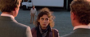 Movie still from “Halloween III: Season of the Witch” (1982), directed by Tommy Lee Wallace – A young woman standing in front of a man; Close Up shot, Over the shoulder angle