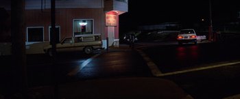 Movie still from “Halloween III: Season of the Witch” (1982), directed by Tommy Lee Wallace – A truck parked on the side of the road at night; Extreme Wide shot, High angle