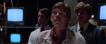 Movie still from “Halloween III: Season of the Witch” (1982), directed by Tommy Lee Wallace – A man with a mustache looking up at the sky; Close Up shot, Low angle