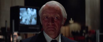 Movie still from “Halloween III: Season of the Witch” (1982), directed by Tommy Lee Wallace – An older man wearing a suit and tie; Close Up shot, Low angle