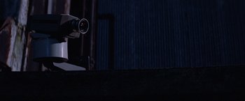 Movie still from “Halloween III: Season of the Witch” (1982), directed by Tommy Lee Wallace – A video camera in a dark room; Extreme Close Up shot, Low angle