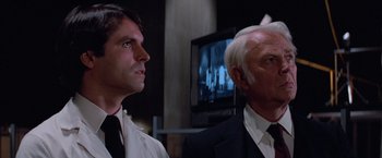 Movie still from “Halloween III: Season of the Witch” (1982), directed by Tommy Lee Wallace – A man and a man wearing a suit and tie; Close Up shot, Low angle