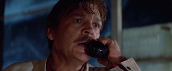 Movie still from “Halloween III: Season of the Witch” (1982), directed by Tommy Lee Wallace – A person talking on a phone; Close Up shot, Low angle