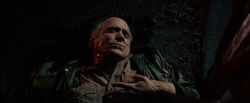 Movie still from “Halloween Kills” (2021), directed by David Gordon Green – A man laying on the ground with blood all over his face; Close Up shot, Overhead angle