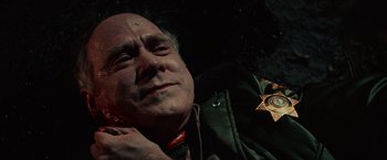 Movie still from “Halloween Kills” (2021), directed by David Gordon Green – An older man wearing a sheriff's badge; Close Up shot, Overhead angle