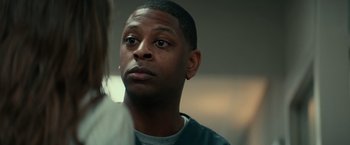 Movie still from “Halloween Kills” (2021), directed by David Gordon Green – A person looking at the camera; Close Up shot, Over the shoulder angle