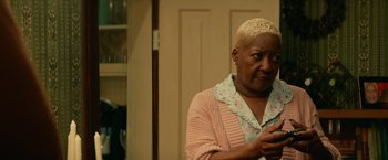 Movie still from “Halloween Kills” (2021), directed by David Gordon Green – An older woman is looking at her cell phone; Close Up shot, Low angle