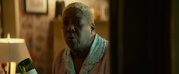 Movie still from “Halloween Kills” (2021), directed by David Gordon Green – An older woman with blonde hair is looking into a mirror; Close Up shot, Low angle