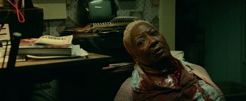 Movie still from “Halloween Kills” (2021), directed by David Gordon Green – An older woman with blonde hair and a bloody face; Close Up shot, High angle