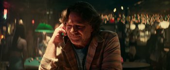 Movie still from “Halloween Kills” (2021), directed by David Gordon Green – A man sitting down talking on a cell phone; Close Up shot, Low angle