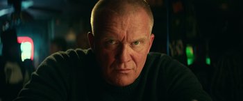 Movie still from “Halloween Kills” (2021), directed by David Gordon Green – An older man with a goatee stares into the camera; Close Up shot, Low angle