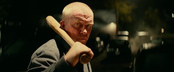 Movie still from “Halloween Kills” (2021), directed by David Gordon Green – A bald man holding a baseball bat in his hands; Close Up shot, Low angle