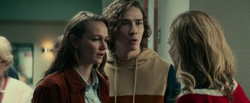 Movie still from “Halloween Kills” (2021), directed by David Gordon Green – A group of people standing next to each other in a room; Close Up shot, Over the shoulder angle