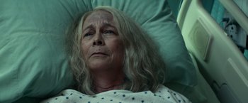 Movie still from “Halloween Kills” (2021), directed by David Gordon Green – An older woman laying in a hospital bed; Close Up shot, Overhead angle