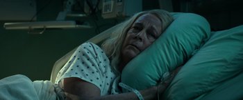 Movie still from “Halloween Kills” (2021), directed by David Gordon Green – An older woman laying in a hospital bed; Close Up shot, High angle