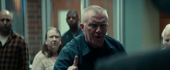 Movie still from “Halloween Kills” (2021), directed by David Gordon Green – A man with a shaved head giving the middle finger; Close Up shot, Over the shoulder angle