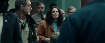 Movie still from “Halloween Kills” (2021), directed by David Gordon Green – A group of people gathered around a woman; Medium shot, Over the shoulder angle