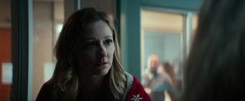 Movie still from “Halloween Kills” (2021), directed by David Gordon Green – A person wearing a red sweater; Close Up shot, Over the shoulder angle