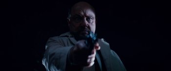 Movie still from “Halloween Kills” (2021), directed by David Gordon Green – A man holding a gun in a dark room; Close Up shot, Low angle