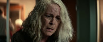 Movie still from “Halloween Kills” (2021), directed by David Gordon Green – An older woman with long white hair looking at the camera; Close Up shot, High angle