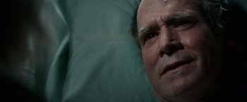 Movie still from “Halloween Kills” (2021), directed by David Gordon Green – An older man with a bald head laying in bed; Close Up shot, Low angle