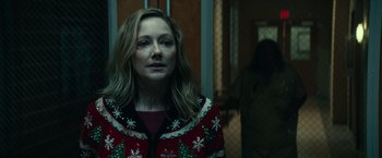 Movie still from “Halloween Kills” (2021), directed by David Gordon Green – A woman wearing a red and green sweater; Close Up shot, Over the shoulder angle