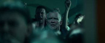 Movie still from “Halloween Kills” (2021), directed by David Gordon Green – A group of people sitting in a dark room; Close Up shot, Low angle