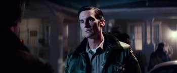Movie still from “Halloween Kills” (2021), directed by David Gordon Green – A man wearing a green jacket and a neck tie; Close Up shot, Low angle