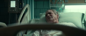 Movie still from “Halloween Kills” (2021), directed by David Gordon Green – An older man laying in a hospital bed; Close Up shot, High angle
