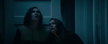 Movie still from “Halloween Kills” (2021), directed by David Gordon Green – A man and a woman standing next to each other in the dark; Medium shot, Low angle