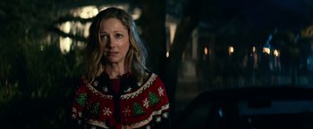 Movie still from “Halloween Kills” (2021), directed by David Gordon Green – A woman wearing a christmas sweater standing next to a car; Close Up shot, Over the shoulder angle