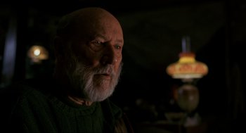 Movie still from “Halloween: The Curse of Michael Myers” (1995), directed by Joe Chappelle – An old man with a beard and a green sweater; Close Up shot, Low angle