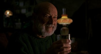 Movie still from “Halloween: The Curse of Michael Myers” (1995), directed by Joe Chappelle – An older man holding a glass of water in his hand; Close Up shot, Low angle