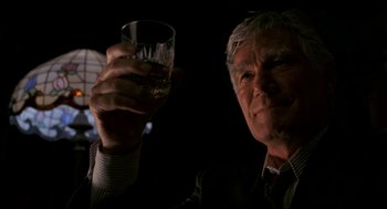 Movie still from “Halloween: The Curse of Michael Myers” (1995), directed by Joe Chappelle – An older man holding up a glass of wine; Close Up shot, Low angle