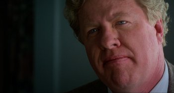 Movie still from “Halloween: The Curse of Michael Myers” (1995), directed by Joe Chappelle – A man's face in a dark room; Close Up shot, Low angle