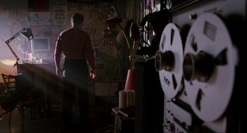 Movie still from “Halloween: The Curse of Michael Myers” (1995), directed by Joe Chappelle – A man standing in front of a projector; Medium shot, Low angle