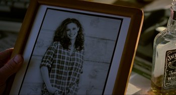 Movie still from “Halloween: The Curse of Michael Myers” (1995), directed by Joe Chappelle – An old picture of a woman in a plaid shirt; Extreme Close Up shot, High angle