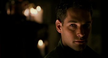 Movie still from “Halloween: The Curse of Michael Myers” (1995), directed by Joe Chappelle – A person's face with lights in the background; Close Up shot, Low angle