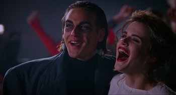 Movie still from “Halloween: The Curse of Michael Myers” (1995), directed by Joe Chappelle – A man and a woman smiling for the camera; Close Up shot, Low angle