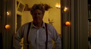 Movie still from “Halloween: The Curse of Michael Myers” (1995), directed by Joe Chappelle – An older man wearing suspenders standing in front of a door; Close Up shot, Low angle