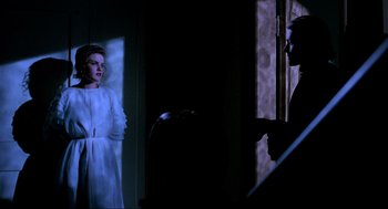 Movie still from “Halloween: The Curse of Michael Myers” (1995), directed by Joe Chappelle – A woman standing in front of a man in a doorway; Medium shot, Over the shoulder angle